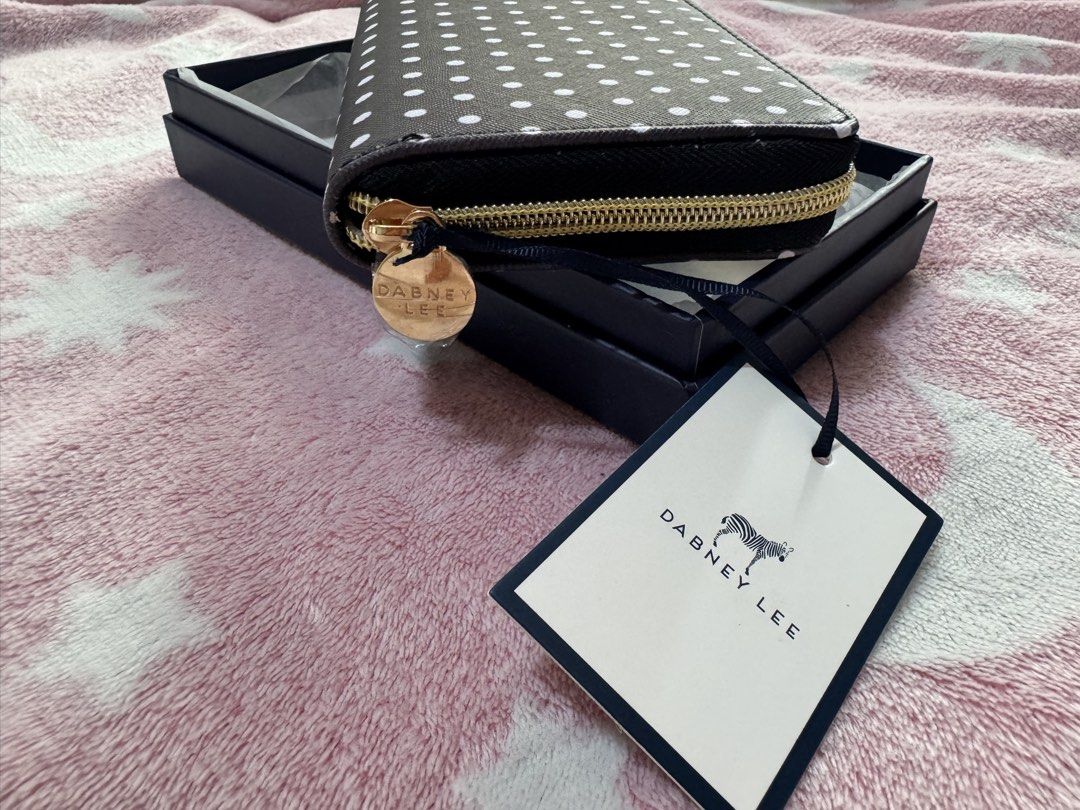 Dabney Lee Black and White Polka Dot Wallet (Category: Wallets & Card holders) located in Mandaluyong City. Submitted by chic_republic (Listing ID 1468987195, Image 3). Description: - Brand: Dabney Lee - Style: Long zip-around wallet - Design: Black with white polka dots and gold-tone hardware - Interior: Navy blue lining with multiple card slots, slip compartments, and a zippered coin pocket - Inclusions: Original box and tag included - Conditio