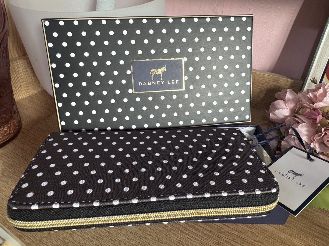 Dabney Lee Black and White Polka Dot Wallet (Category: Wallets & Card holders) located in Mandaluyong City. Submitted by chic_republic (Listing ID 1468987195, Image 1). Description: - Brand: Dabney Lee - Style: Long zip-around wallet - Design: Black with white polka dots and gold-tone hardware - Interior: Navy blue lining with multiple card slots, slip compartments, and a zippered coin pocket - Inclusions: Original box and tag included - Conditio