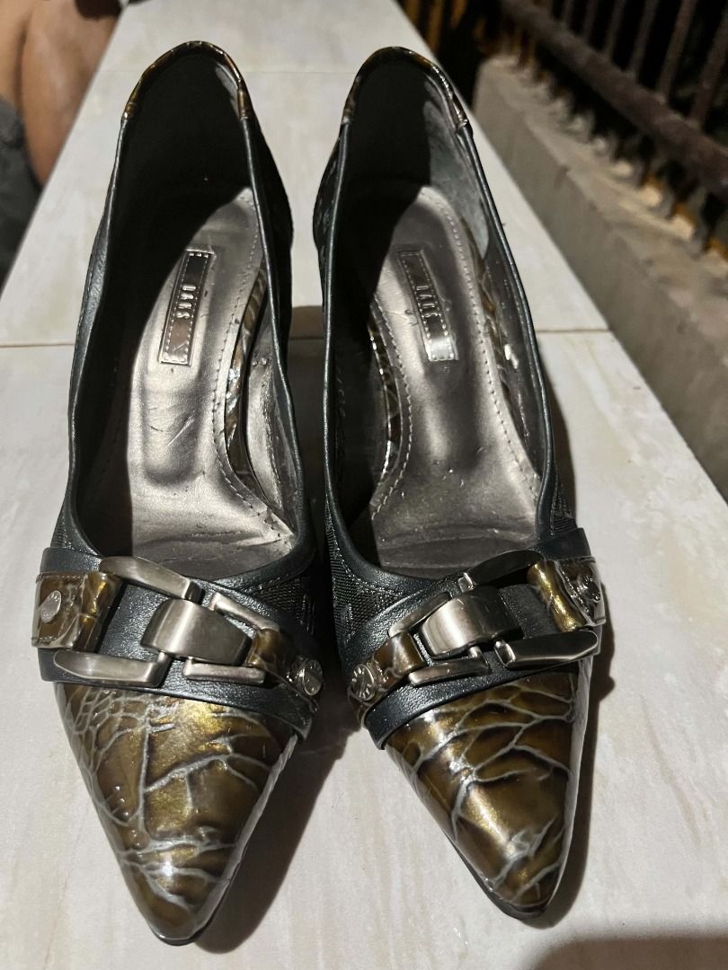 Daks pointed toe heels with buckle detail (Category: Heels) located in Davao. Submitted by bravecat.edef3f (Listing ID 1468936324, Image 2). Description: - Brand: Daks - Color: Bronze and black - Heel type: Medium kitten heel - Design: Pointed toe with metallic buckle, patterned fabric sides, and glossy crackle-effect toe cap and heel counter - Condition: Interior shows minor wear along the lining edge.