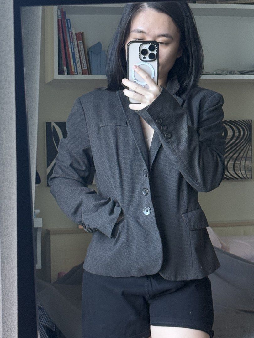 Dark Grey Tailored Office Blazer with Button Cuffs (Category: Coats, Jackets and Outerwear) located in Pasig City. Submitted by laagn.ph (Listing ID 1469090160, Image 2). Description: - Color: Dark grey with subtle texture - Fit: Fitted silhouette with structured shoulders - Details: Notched lapels, front button closure, decorative cuff buttons - Pockets: Functional hip flap pockets - Style: Versatile professional wear and great layering piece fo