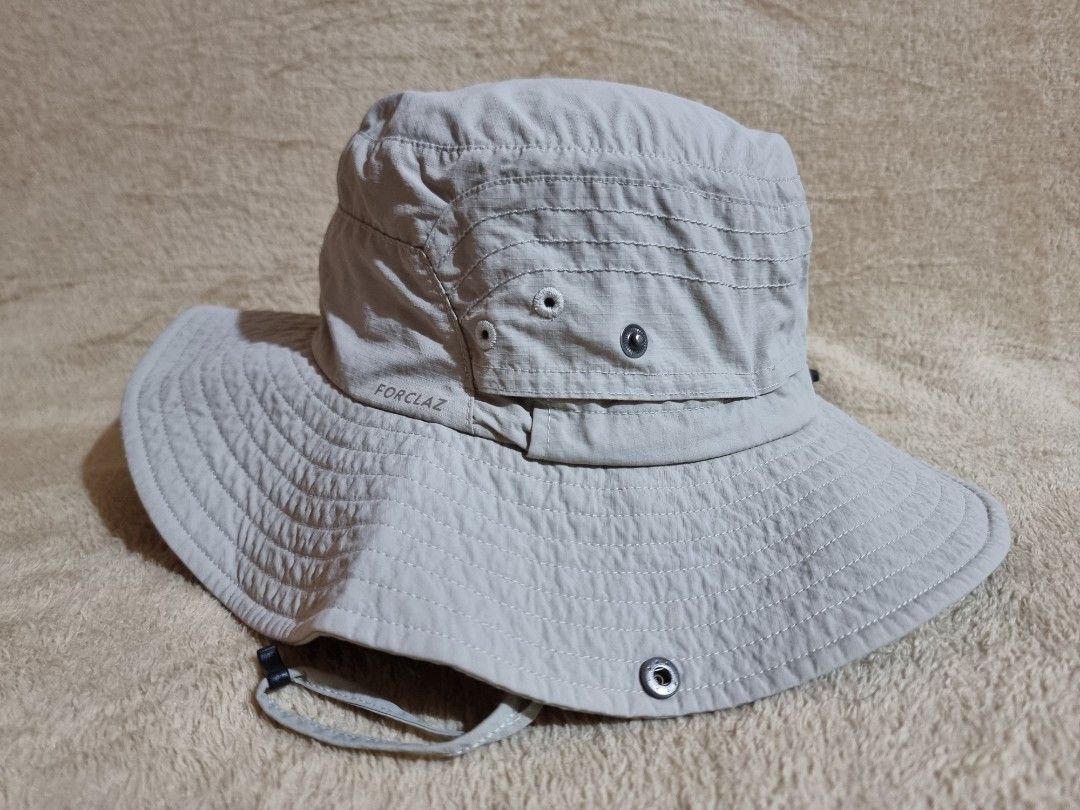 Decathlon Forclaz Trekking Bucket Hat (Category: Caps & Hats) located in Imus. Submitted by aim_for_less (Listing ID 1469050579, Image 2). Description: Decathlon Forclaz Trekking Bucket Hat - Brand/Model: Forclaz Outdoor Sun Hat - SZIE: M/L (58-60cm) - Color: Light grey - Wide brim provides solid shade for hiking and trekking - Secure adjustable chin strap with toggle for windy days - Side ventilation eyelets to keep your head cool - Back drawstr