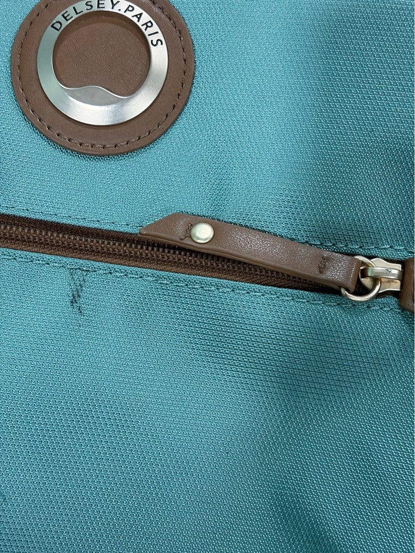 Delsey Paris Freestyle Teal Backpack (Category: Backpacks) located in Quezon City. Submitted by ewyeung (Listing ID 1468998593, Image 3). Description: - Brand: Delsey Paris -Freestyle Backpack made from rPET Bought from HK - Color: Teal green with brown leather-look trim and gold-tone hardware - Storage: Multiple front and side zippered pockets for easy organization - Comfort: Padded shoulder straps and sturdy top handle - Material: Durable synth