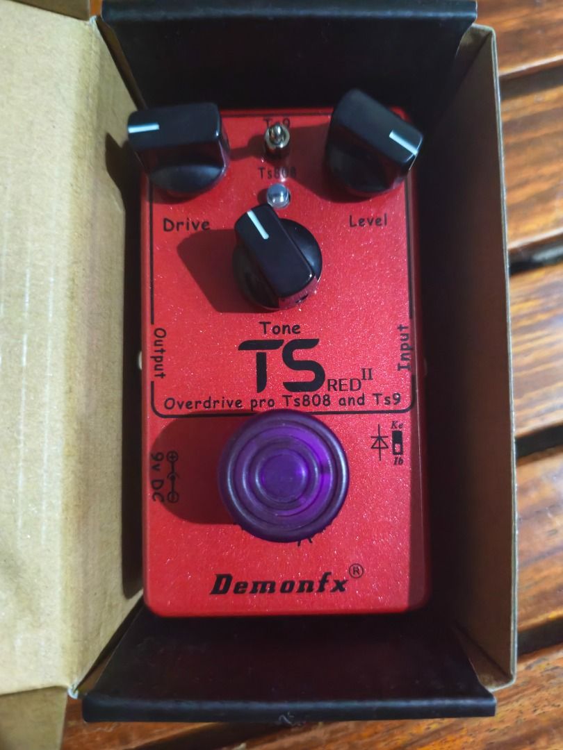 Demonfx TS Red II Overdrive Pedal (Category: Musical Instruments) located in Cabanatuan. Submitted by lskakarot (Listing ID 1469108927, Image 1). Description: - Brand: Demonfx TS Red II Overdrive Pedal - Modes: Switchable between TS808 and TS9 via toggle switch - Controls: Drive, Tone, and Level knobs - Aesthetics: Stunning red sparkly finish with black lettering and a purple footswitch topper - Power: Requires 9V DC - Inclusion: Original box inc