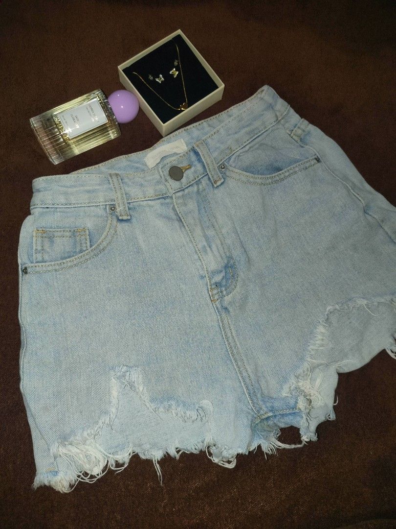 Denim shorts with raw hem and text graphic (Category: Shorts) located in Las Pinas. Submitted by alkwinuts (Listing ID 1469159856, Image 3). Description: - Style: High-waisted black washed denim shorts with an edgy vibe - Closure: Classic button fly - Details: Raw frayed hems and back pocket graphic text reading 'I want your mouth on my body right now.' - Pockets: Functional front and back pockets - Versatility: Great for casual day wear or styli
