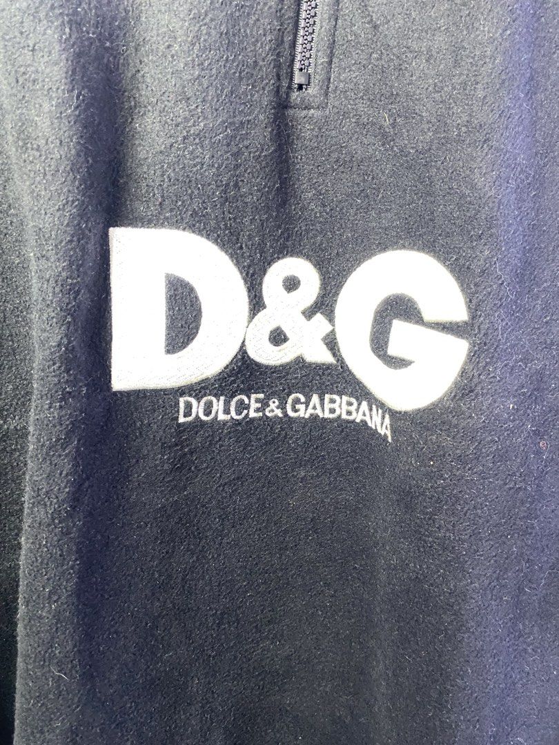 D&G Dolce & Gabbana Black Fleece Quarter Zip Pullover (Category: Coats, Jackets and Outerwear) located in Manila. Submitted by declutterpromax (Listing ID 1469002123, Image 3). Description: - Brand: D&G Dolce & Gabbana - Item: Black fleece quarter-zip pullover - Branding: Large embroidered logo on front chest, small logo on upper back - Details: High contrasting white collar lining, adjustable drawstring hem - Material: 100% polyester - Origin: M