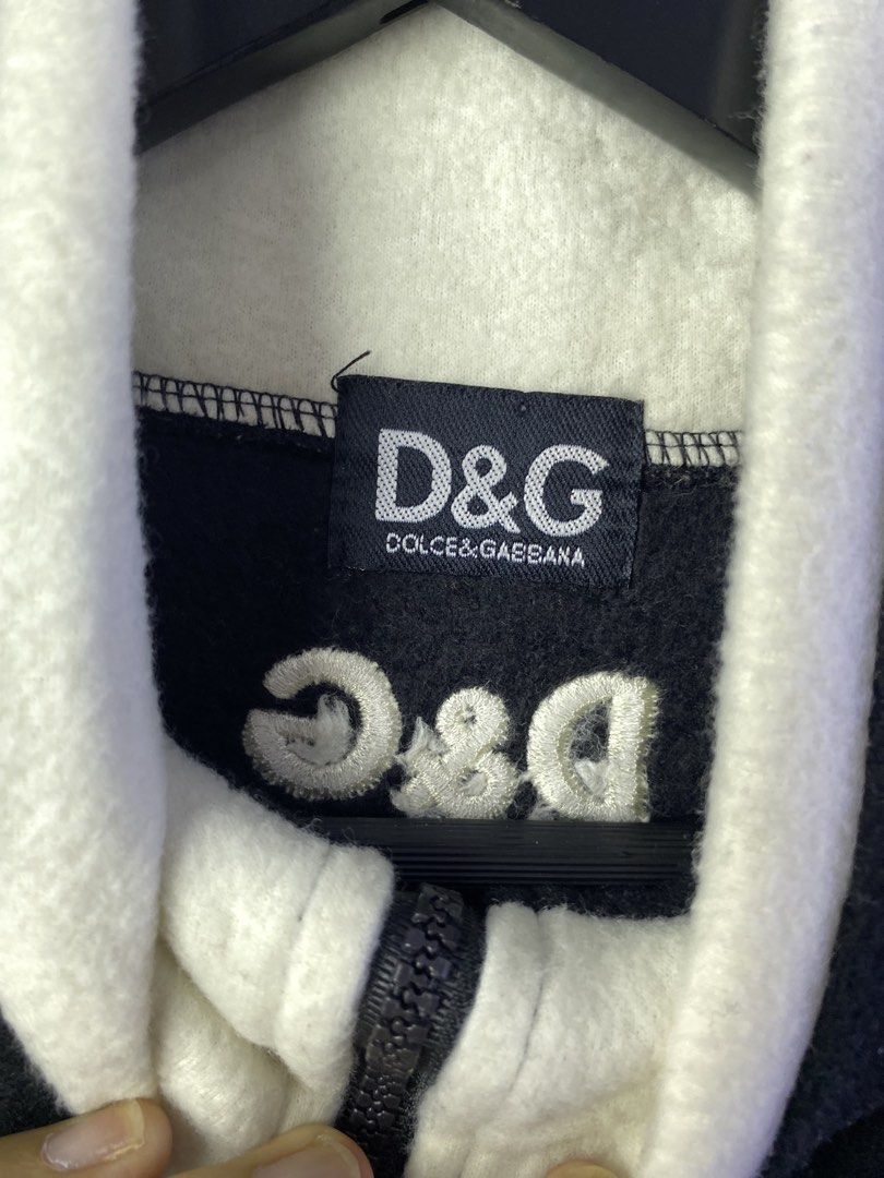 D&G Dolce & Gabbana Black Fleece Quarter Zip Pullover (Category: Coats, Jackets and Outerwear) located in Manila. Submitted by declutterpromax (Listing ID 1469002123, Image 2). Description: - Brand: D&G Dolce & Gabbana - Item: Black fleece quarter-zip pullover - Branding: Large embroidered logo on front chest, small logo on upper back - Details: High contrasting white collar lining, adjustable drawstring hem - Material: 100% polyester - Origin: M