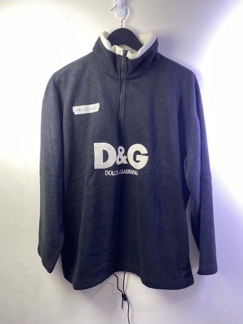 D&G Dolce & Gabbana Black Fleece Quarter Zip Pullover (Category: Coats, Jackets and Outerwear) located in Manila. Submitted by declutterpromax (Listing ID 1469002123, Image 1). Description: - Brand: D&G Dolce & Gabbana - Item: Black fleece quarter-zip pullover - Branding: Large embroidered logo on front chest, small logo on upper back - Details: High contrasting white collar lining, adjustable drawstring hem - Material: 100% polyester - Origin: M