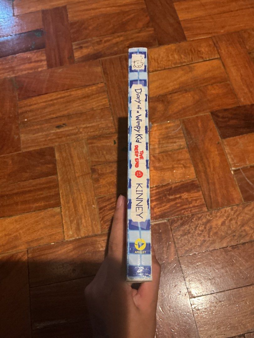 Diary of a Wimpy Kid: The Deep End (Category: Children's Books) located in Muntinlupa City. Submitted by antonrizz (Listing ID 1469043513, Image 3). Description: - Title: Diary of a Wimpy Kid: The Deep End (Book 15) - Author: Jeff Kinney - Publisher: Amulet Books - Format: Softcover / Standard paperback size - Plot: Greg Heffley and family go on a wild, cross-country camping trip - Condition: Brand new / Great read for fans - Shipping: Fast shipp