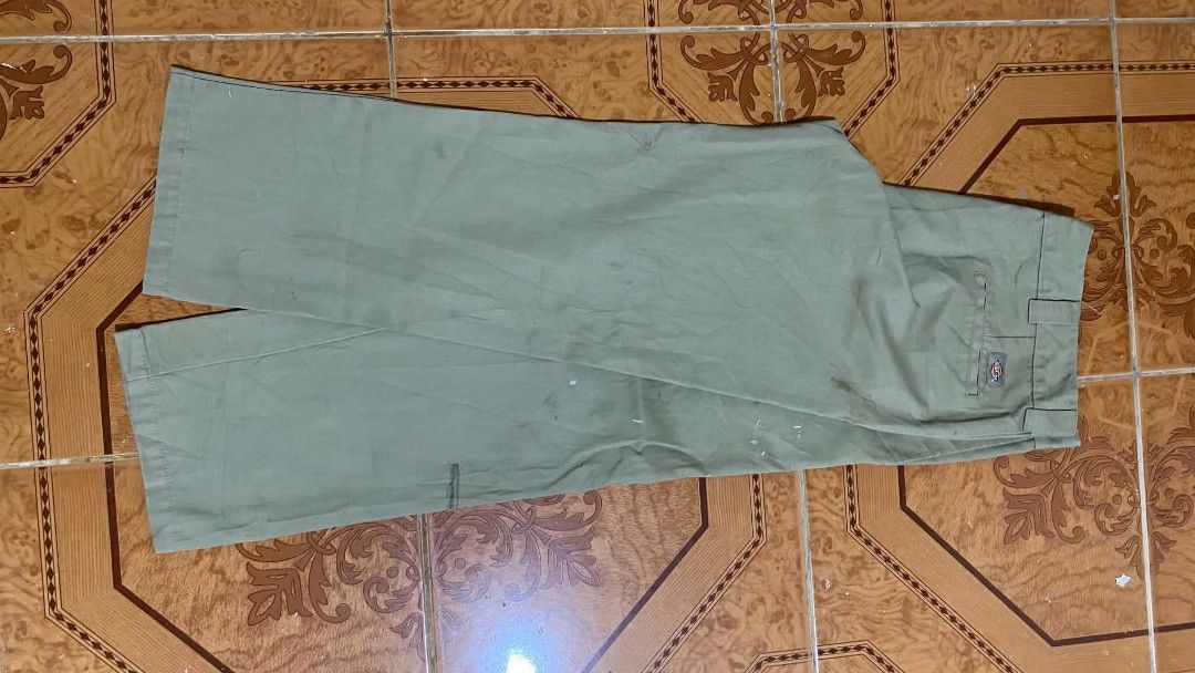 Dickies Slim Straight Pants Olive Green (Category: Trousers) located in Bulacan. Submitted by rondeez (Listing ID 1468950187, Image 2). Description: - Brand: Dickies - Style: Slim straight work pants - Color: Olive green - Details: Classic style, belt loops, and back welt pockets - Fit: Tagged slim straight fit - Condition: Has noticeable stains and marks scattered on the fabric from previous wear.