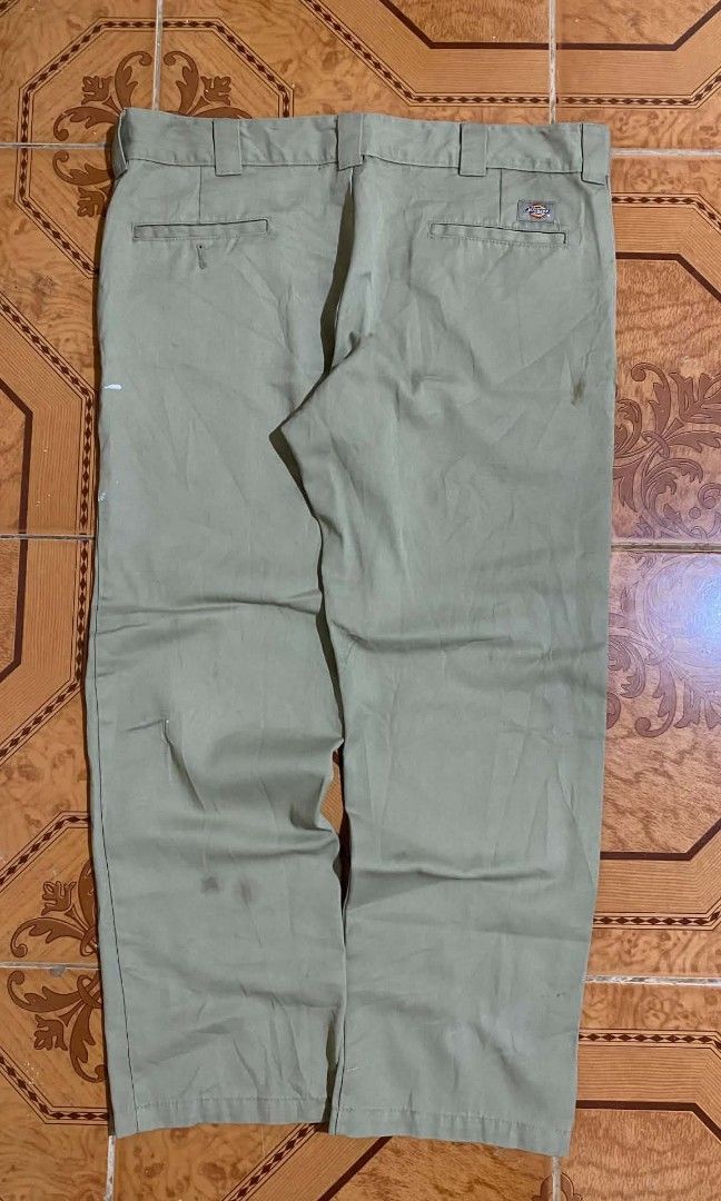 Dickies Slim Straight Pants Olive Green (Category: Trousers) located in Bulacan. Submitted by rondeez (Listing ID 1468950187, Image 1). Description: - Brand: Dickies - Style: Slim straight work pants - Color: Olive green - Details: Classic style, belt loops, and back welt pockets - Fit: Tagged slim straight fit - Condition: Has noticeable stains and marks scattered on the fabric from previous wear.