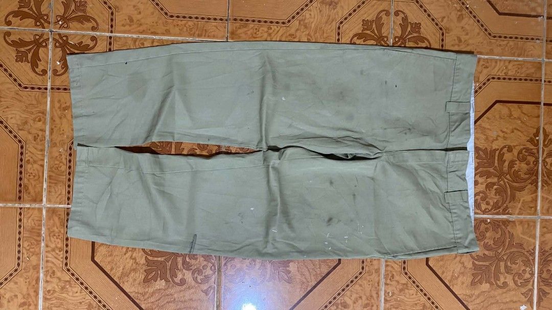 Dickies Slim Straight Pants Olive Green (Category: Trousers) located in Bulacan. Submitted by rondeez (Listing ID 1468950187, Image 3). Description: - Brand: Dickies - Style: Slim straight work pants - Color: Olive green - Details: Classic style, belt loops, and back welt pockets - Fit: Tagged slim straight fit - Condition: Has noticeable stains and marks scattered on the fabric from previous wear.