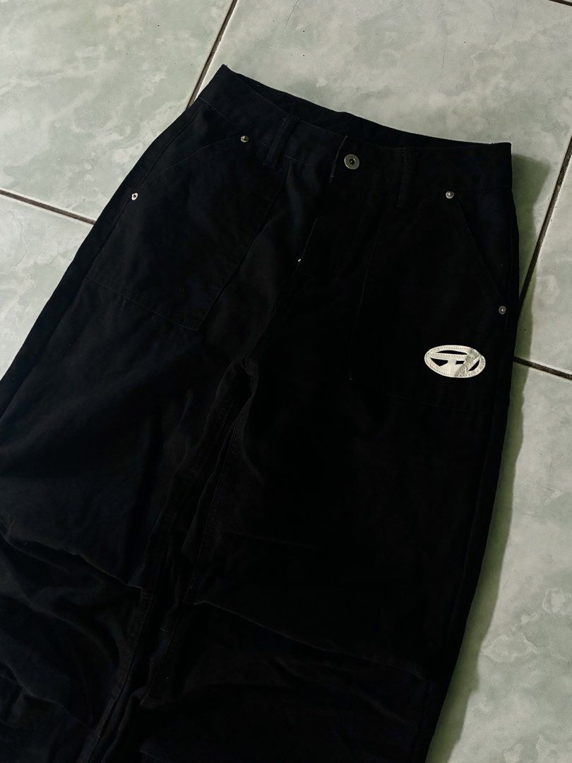 Diesel Black Baggy Denim Pants (Category: Jeans) located in Batangas. Submitted by jinventoryarchive (Listing ID 1469059255, Image 2). Description: Waist: 27-28 Length: 40 Leg Op: 11 Thigh: 11 - Color & Style: Black denim pants with a wide-leg fit and cool panel detailing - Branding: Distinctive white Diesel oval logo patch - Hardware: Silver-tone hardware with button closure and belt loops - Fit: Inner drawstring waistbands for an adjustable, co