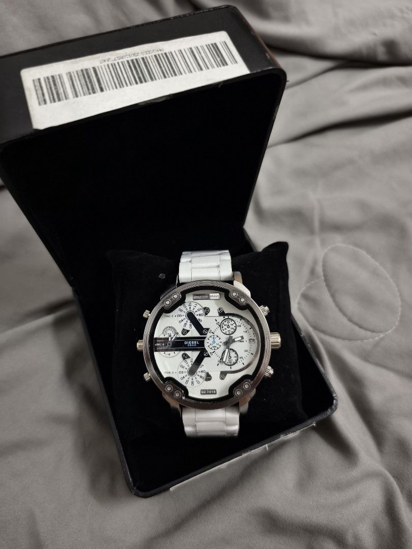 Diesel DZ-7418 White Chronograph Watch (Category: Men's Watches) located in Angeles City. Submitted by measaliman02351 (Listing ID 1469112134, Image 1). Description: - Brand/Model: Diesel DZ-7418 - Color: White and silver - Design: Bold large face with multiple dials and four separate time zones - Strap: Ceramic and stainless steel bracelet with deployment clasp - Inclusion: Original black presentation box with barcode sleeve - Condition: Excelle