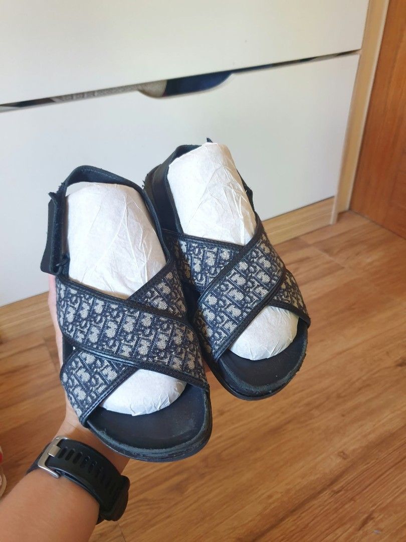 Dior Oblique Pattern Cross Strap Sandals Black (Category: Babies & Kids Fashion) located in Laoag. Submitted by alyssamarie_2918 (Listing ID 1468982968, Image 3). Description: - Authentic-style black sandals with classic Dior oblique jacquard pattern - Adjustable velcro back strap for a secure and easy fit - Comfortable leather footbed for all-day wear - Comes with paper stuffing inside to maintain original shape - Stylish and casual footwear sta