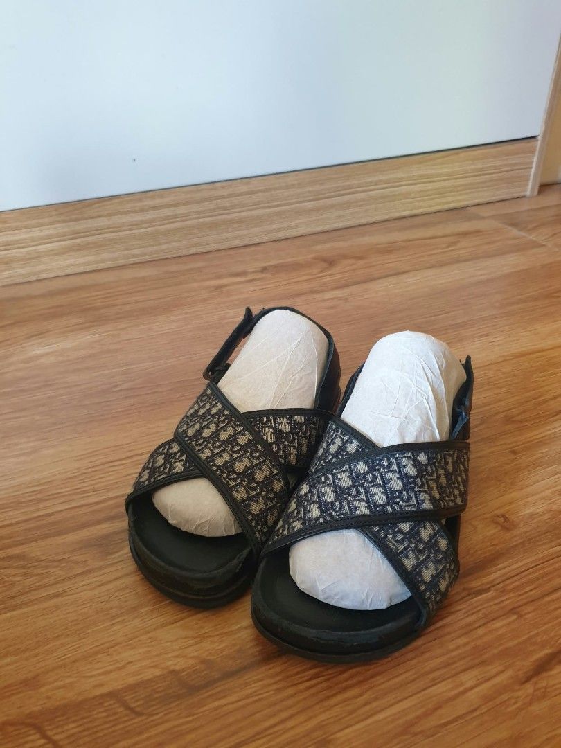 Dior Oblique Pattern Cross Strap Sandals Black (Category: Babies & Kids Fashion) located in Laoag. Submitted by alyssamarie_2918 (Listing ID 1468982968, Image 2). Description: - Authentic-style black sandals with classic Dior oblique jacquard pattern - Adjustable velcro back strap for a secure and easy fit - Comfortable leather footbed for all-day wear - Comes with paper stuffing inside to maintain original shape - Stylish and casual footwear sta
