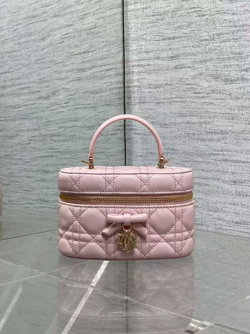 Dior Pink Cannage Leather Vanity Case (Category: Luxury Bags & Wallets) located in Navotas City. Submitted by ciputsurti69538 (Listing ID 1469021485, Image 2). Description: - Authentic Pink Dior Vanity Bag - Crafted from luxurious lambskin leather with classic Cannage quilting - Elegant top handle design with polished gold-tone hardware - Cute front bow accent featuring dangling Dior charms - Secure zip-around closure - Pink leather interior with