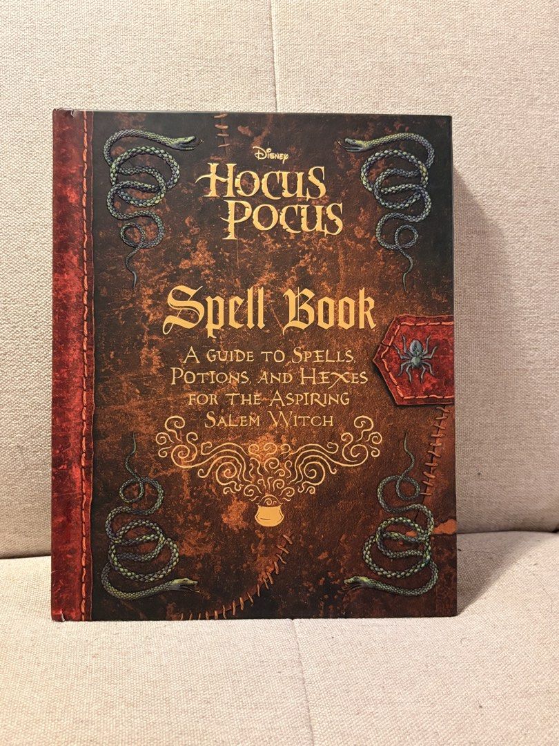 Disney Hocus Pocus Spell Book (Category: Children's Books) located in Pasig City. Submitted by shitaku.ph (Listing ID 1469111392, Image 2). Description: - Official Disney Hocus Pocus hardcover spell book: A Guide to Spells, Potions, and Hexes for the Aspiring Salem Witch - Distressed brown and red cover featuring snake illustrations and a spider patch graphic - Clean inside pages complete with unique illustrations and spell sections including Ang