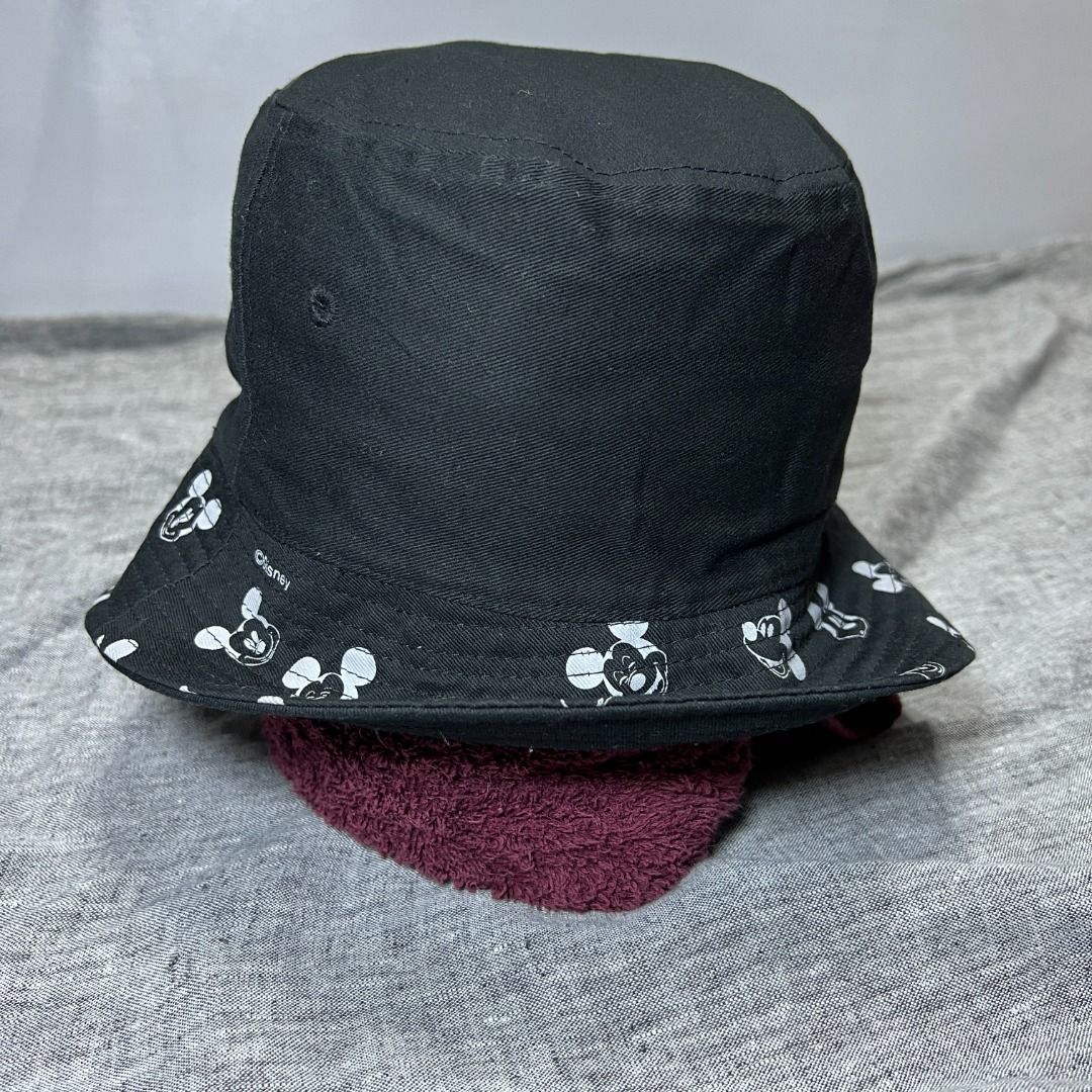 Disney Mickey Mouse Black Embroidered Reversible Bucket Hat (Category: Hats & Beanies) located in Talisay. Submitted by sidequested.archive (Listing ID 1469079372, Image 2). Description: 📝Details • Condition: Pre-loved in good overall condition with clean Mickey Mouse embroidery and printed brim; minor signs of wear and light lint visible. • Color rating: 10/10 • Measurements (in inches): 22 inches ( M - L ) Overall rating: 10/10 💰 Price: ₱350 