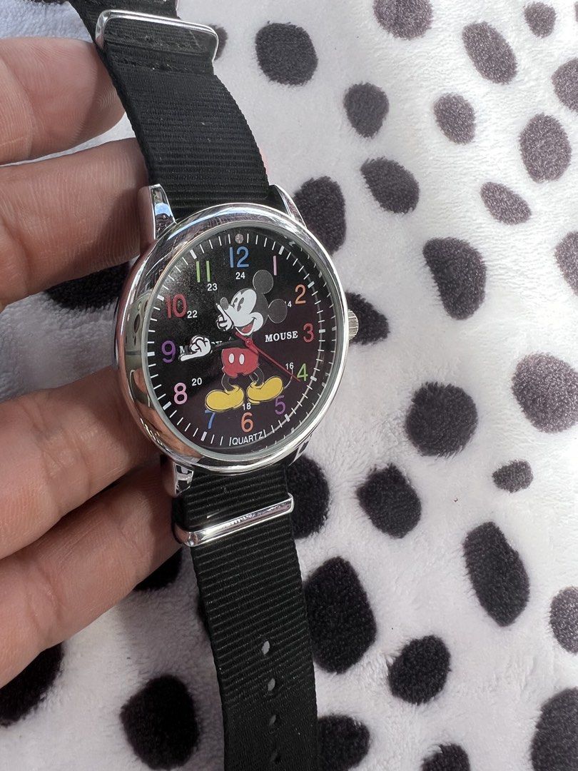 Disney Mickey Mouse Black Fabric Strap Quartz Watch (Category: Men's Watches) located in Rizal. Submitted by imallari88 (Listing ID 1469013130, Image 1). Description: - Brand: Disney Mickey Mouse - Movement: Quartz - Design: Classic Mickey illustration with vibrant colorful numbers on the dial - Materials: Silver-tone case and comfortable black fabric strap with metal buckle - Fit: Fully adjustable, standard wrist fit - Details: Water-resistant c