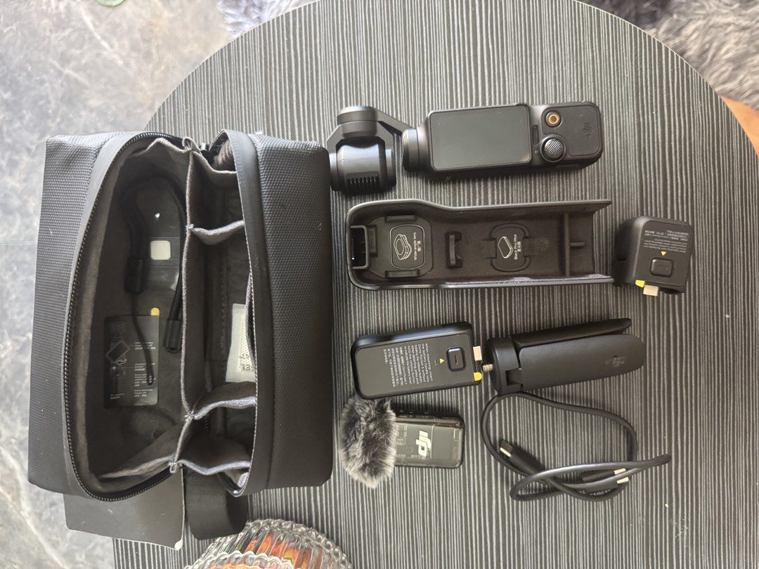 DJI Osmo Pocket 3 Creator Combo Camera Kit (Category: Cameras) located in Pasig City. Submitted by acombalecer (Listing ID 1468967976, Image 2). Description: - Complete DJI Osmo Pocket 3 Creator Combo set - Fully tested and 100% working condition - Includes camera with rotating touchscreen and battery handle - Comes with DJI Mic 2 transmitter and deadcat wind muff - Includes mini tripod, protective cover, and USB-C cable - Everything packs away n
