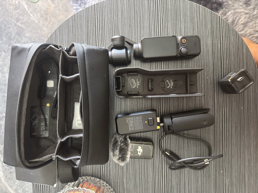 DJI Osmo Pocket 3 Creator Combo Camera Kit (Category: Cameras) located in Pasig City. Submitted by acombalecer (Listing ID 1468967976, Image 1). Description: - Complete DJI Osmo Pocket 3 Creator Combo set - Fully tested and 100% working condition - Includes camera with rotating touchscreen and battery handle - Comes with DJI Mic 2 transmitter and deadcat wind muff - Includes mini tripod, protective cover, and USB-C cable - Everything packs away n
