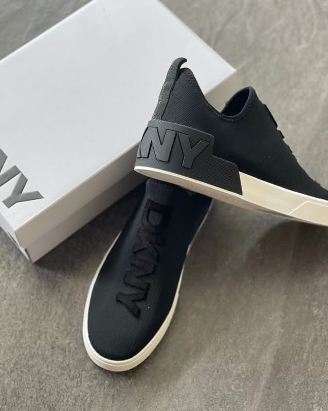 DKNY Black Slip-On Sneakers with Box (Category: Sneakers) located in Caloocan City. Submitted by Roowchelly (Listing ID 1469125052, Image 2). Description: - Brand: DKNY - Color: Black with white sole - Style: Slip-on sneakers with bold raised logo lettering on top and heel - Material: Comfortable and breathable knit fabric upper - Inclusions: Original white DKNY brand box - Condition: Excellent / Like new - Perfect for casual, on-the-go styling W