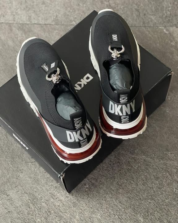 DKNY Black Zipper Platform Sneakers With Original Box (Category: Sneakers) located in Caloocan City. Submitted by Roowchelly (Listing ID 1469124644, Image 3). Description: - Brand: DKNY - Color: Black with chunky white and red sole - Style: Zip-up front with branded pull tab and slip-on stretchy knit upper - Details: Bold DKNY lettering on heel strap and pull loop - Inclusions: Original black shoebox included - Condition: Well-maintained and read