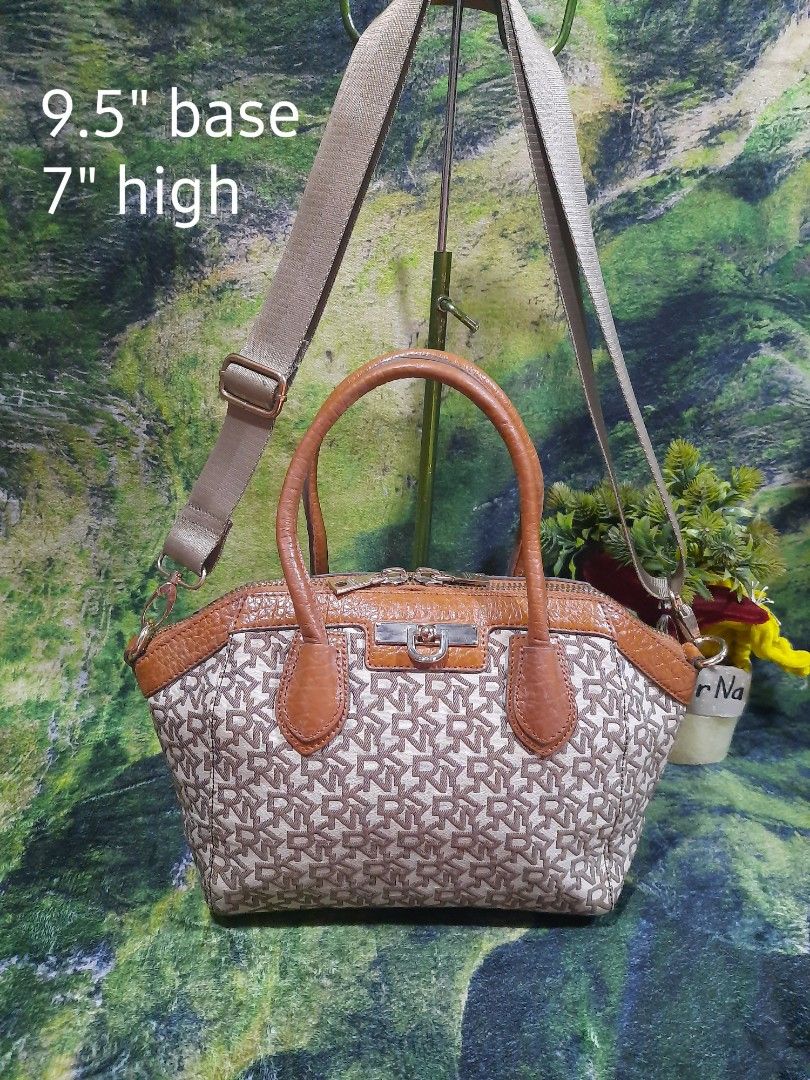 DKNY Monogram Crossbody Handbag Brown Beige (Category: Luxury Bags & Wallets) located in Baguio. Submitted by klayblakeb87803 (Listing ID 1469049647, Image 1). Description: - Brand: DKNY - Material: Signature monogram canvas with textured tan leather trim - Color: Brown and beige tones - Closure: Dual zipper with branded metal pulls - Handles & Strap: Dual top handles plus a detachable, adjustable crossbody strap - Protection: Bottom panel featur