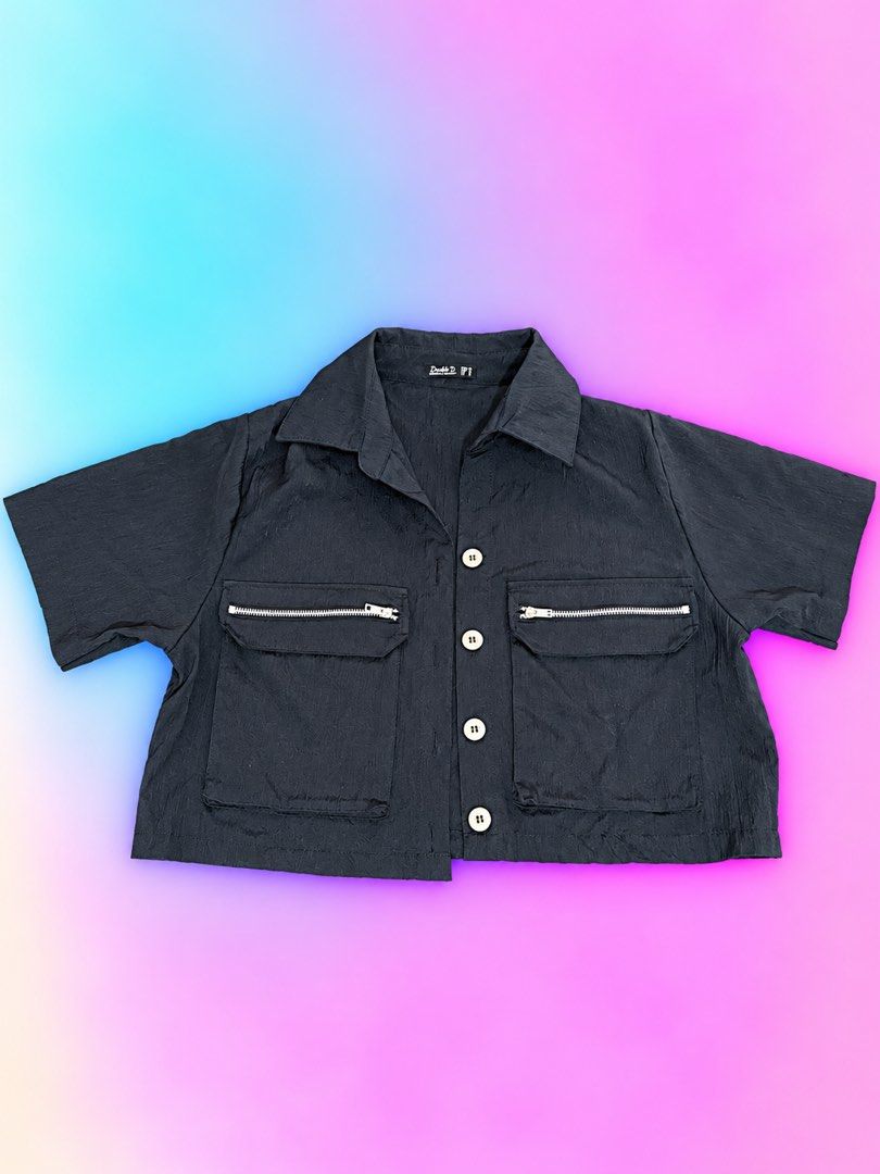 Double D Black Button-Up Shirt with Utility Pockets (Category: Shirts) located in Quezon City. Submitted by turtleandfishes (Listing ID 1468933834, Image 1). Description: - Brand: Double D - Color: Black - Style: Utility short-sleeve button-up shirt with collared neckline and silver metal hardware - Details: Two large front pockets with zipper accents on the flaps, lightweight crinkled texture fabric - Measurements: Pit-to-pit approx. 22.5", Tota