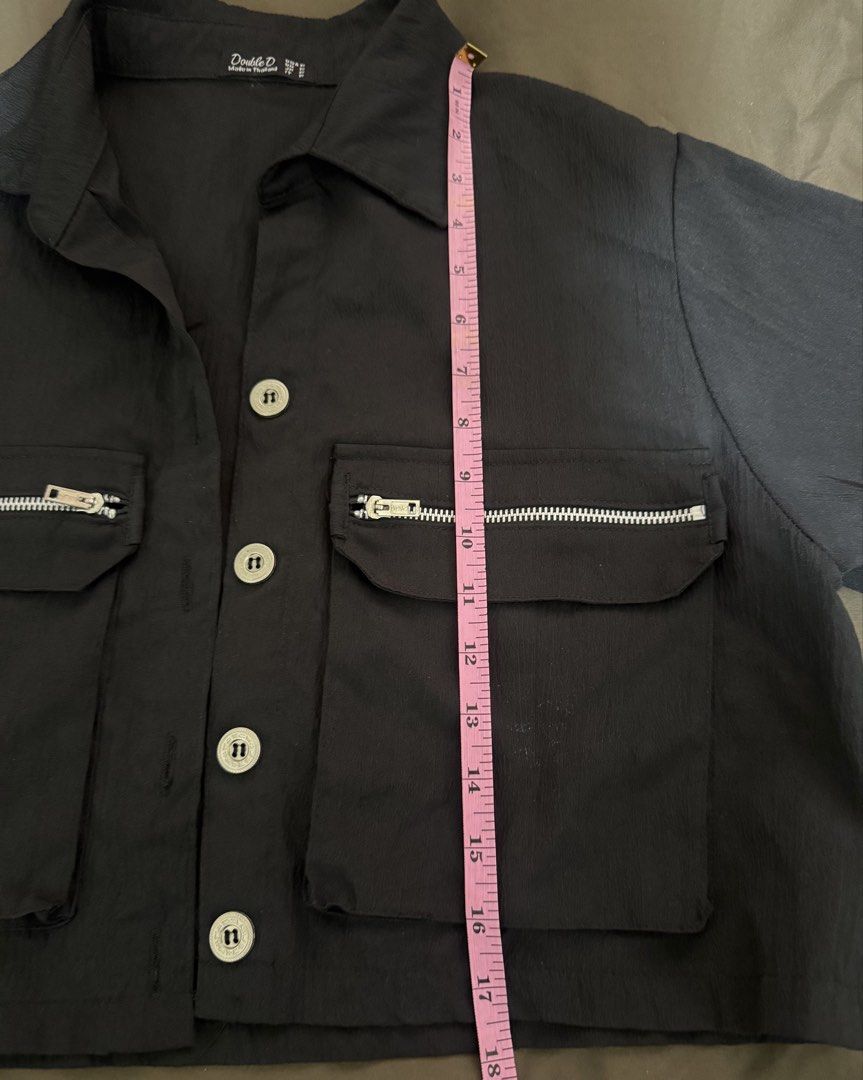 Double D Black Button-Up Shirt with Utility Pockets (Category: Shirts) located in Quezon City. Submitted by turtleandfishes (Listing ID 1468933834, Image 3). Description: - Brand: Double D - Color: Black - Style: Utility short-sleeve button-up shirt with collared neckline and silver metal hardware - Details: Two large front pockets with zipper accents on the flaps, lightweight crinkled texture fabric - Measurements: Pit-to-pit approx. 22.5", Tota
