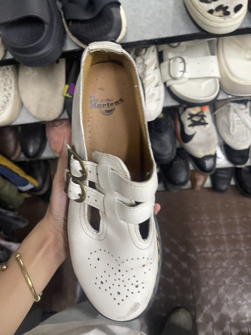 Dr. Martens White Multi-Strap Mary Jane Shoes (Category: Flats & Sandals) located in Balanga. Submitted by crowjo (Listing ID 1469060075, Image 3). Description: - Brand: Dr. Martens - Style: Mary Jane with double buckle straps & antique brass hardware - Color: Classic White - Details: Brogue toe perforation & iconic yellow sole stitching - Condition: Visible scuffing on the front toe area, interior logo stamp intact - Perfect for: Edgy, school-gi