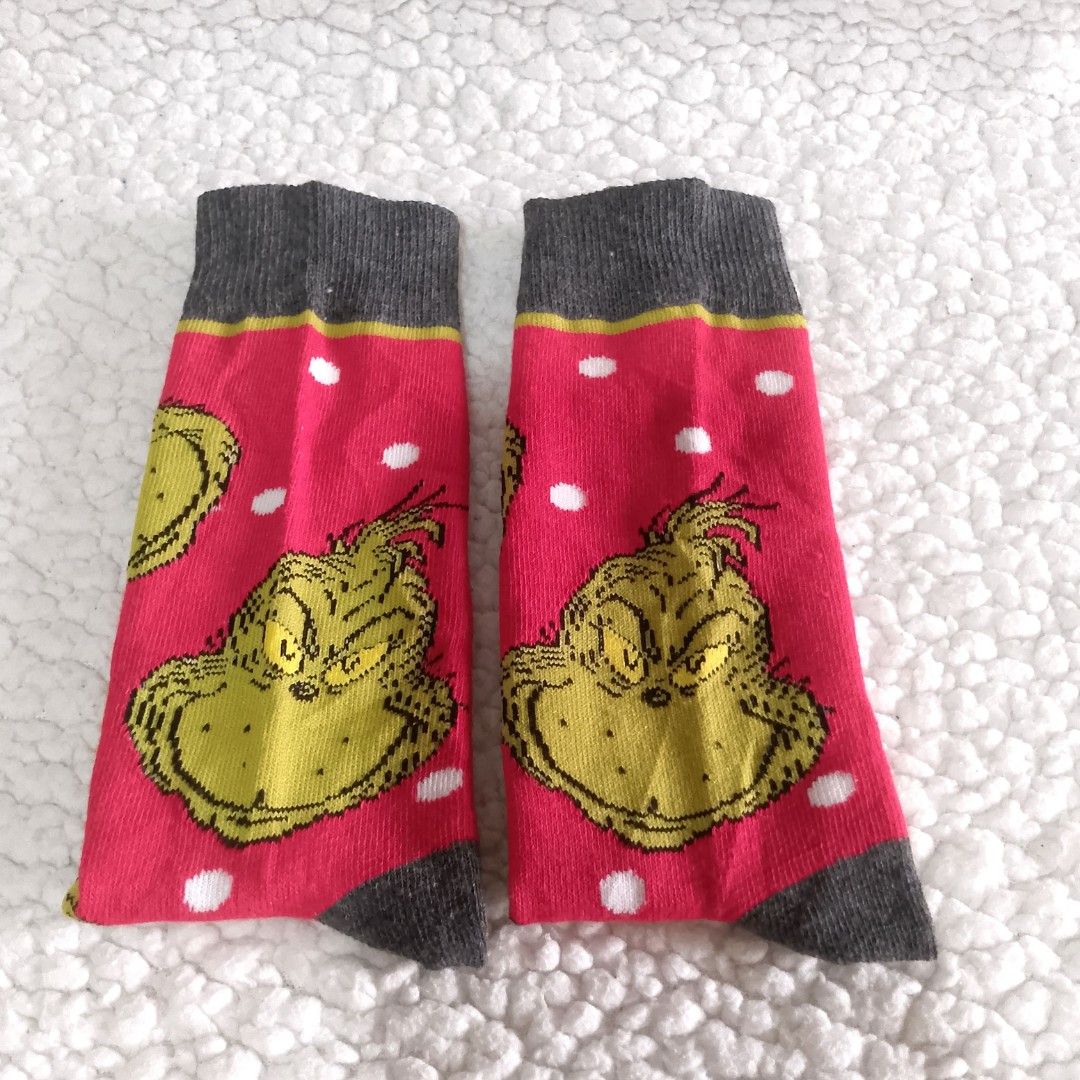 The Grinch Christmas Crew Socks (Category: Socks) located in Tuguegarao City. Submitted by thriftedtreasures101.1 (Listing ID 1468949095, Image 3). Description: It features a Red body patterned with White polka dots, an all-over repeating print of the Grinch's iconic scowling face and a Dark Grey accents along the top cuffs, heels and toes. Slightly used, in very condition with small flaw as shown on the last picture. Color may vary due to lighti
