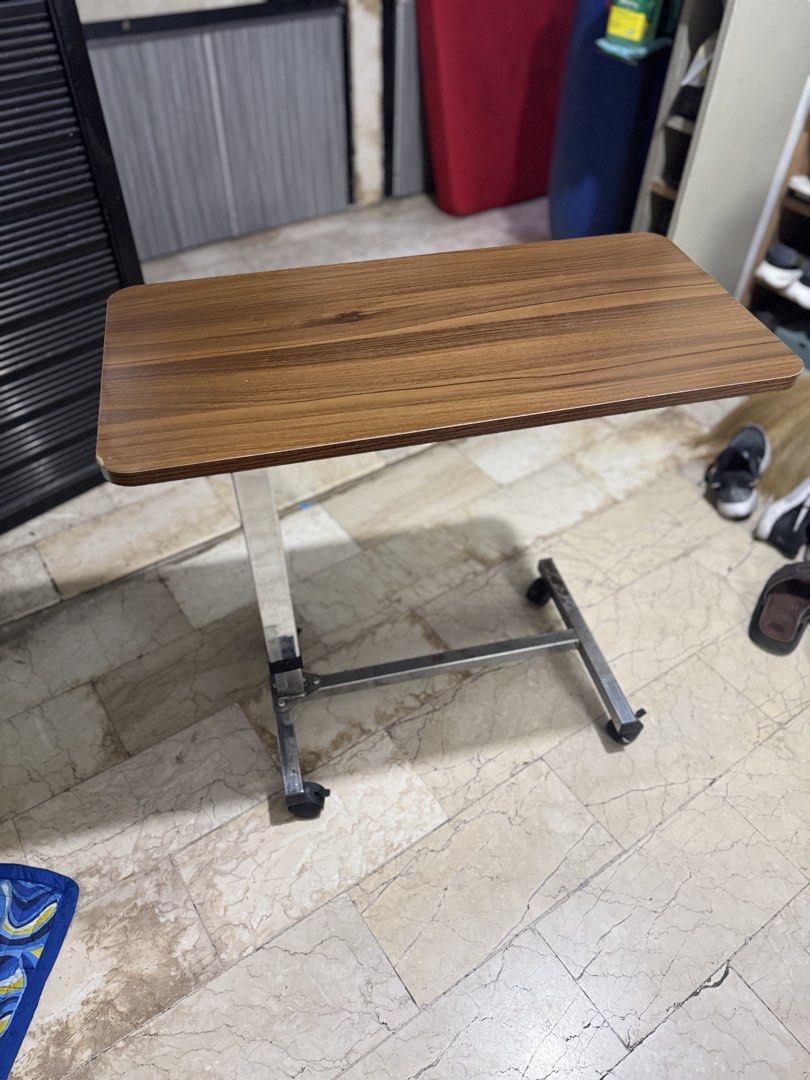 Drive Medical Overbed Table with Wheels (Category: Medical Supplies & Tools) located in Quezon City. Submitted by chi__028 (Listing ID 1468985368, Image 1). Description: - Features: Height-adjustable stem and smooth-rolling casters on an H-style base - Materials: Wood-grain top and durable chrome steel base - Condition: Fully functional and sturdy - Ideal Use: Great bedside table for meals, reading, or laptop use.