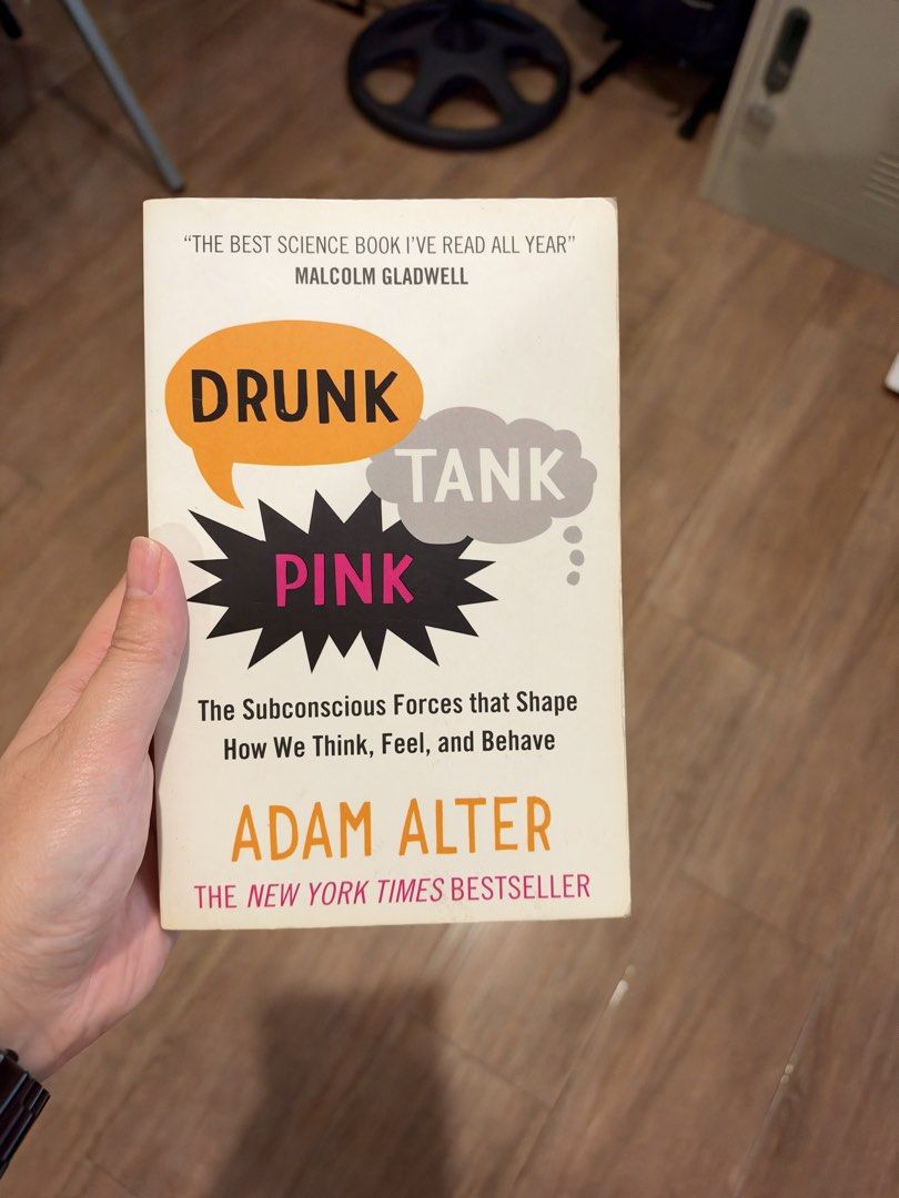 Drunk Tank Pink by Adam Alter (Category: Storybooks) located in Manila. Submitted by garagesalebykoda (Listing ID 1468986857, Image 1). Description: - Title & Author: Drunk Tank Pink by Adam Alter - Publisher: Oneworld (ISBN: 978-1-78074-583-1) - Genre: Explores how subconscious forces shape everyday thinking, feeling, and behavior - Condition: Read once, stored on a shelf; shows normal page tanning from age and slight shelf wear at the edges - F