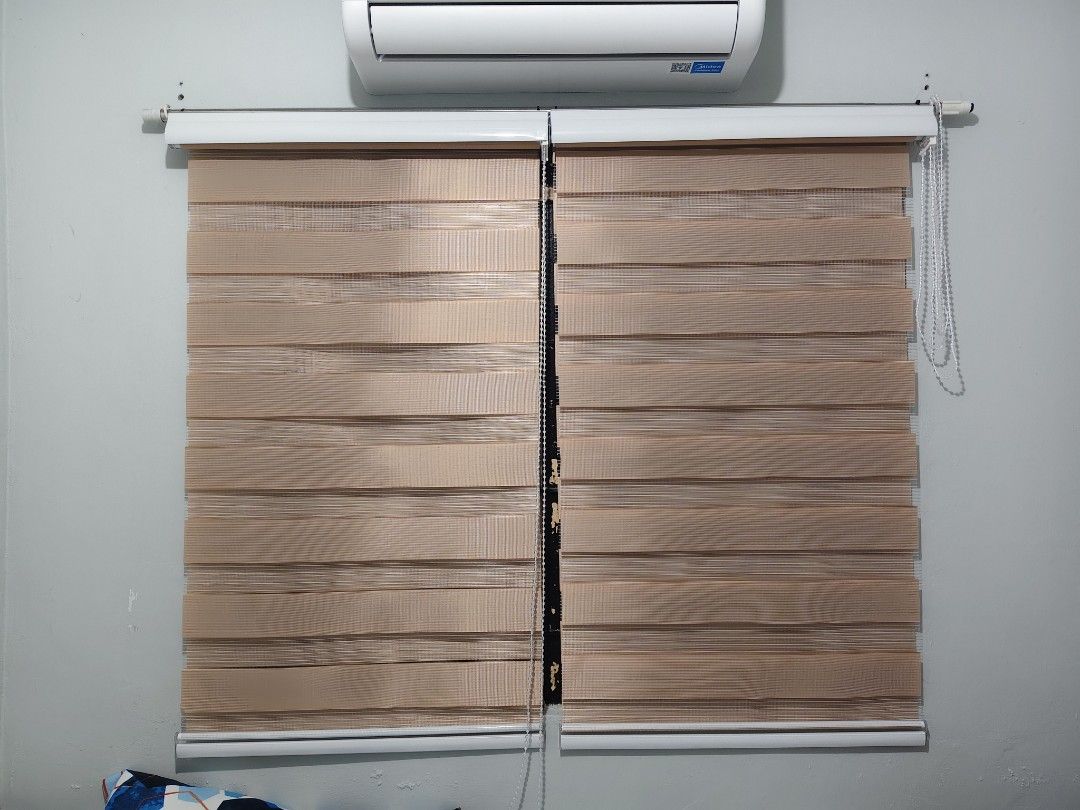 Dual layer zebra roller blinds brown roller shades window treatment (Category: Curtains & Blinds) located in Manila. Submitted by paulaceejay14 (Listing ID 1469058318, Image 2). Description: - Item: Double layer zebra roller blinds - Color: Light Brown - Design: Striped fabric for adjustable light filtering - Operation: Easy pull cord adjustment - Style: Clean, modern look perfect for bedroom or living room - Inclusion: Comes with wall brackets, 