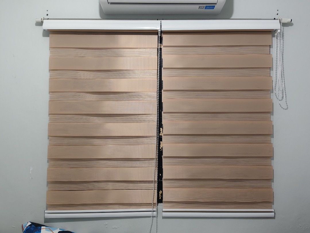 Dual layer zebra roller blinds brown roller shades window treatment (Category: Curtains & Blinds) located in Manila. Submitted by paulaceejay14 (Listing ID 1469058318, Image 1). Description: - Item: Double layer zebra roller blinds - Color: Light Brown - Design: Striped fabric for adjustable light filtering - Operation: Easy pull cord adjustment - Style: Clean, modern look perfect for bedroom or living room - Inclusion: Comes with wall brackets, 