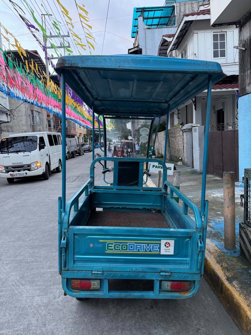 E-Cargo 650J Electric Tricycle Blue (Category: Motorbikes for Sale) located in Manila. Submitted by alendlr (Listing ID 1468974786, Image 3). Description: Battery need replacement Headlight not working No switch See UNIT in person. Blue utility electric tricycle, model E-Cargo 650J. Fitted with a covered roof, front windshield, front passenger seat, and a rear cargo bed with drop-down side panels. Powered transport for deliveries or passenger hau