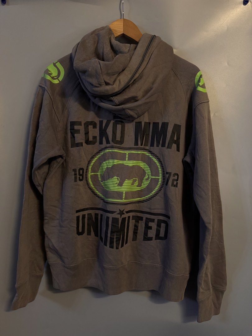 Ecko Unltd MMA Gray Full Zip Hoodie (Category: Coats, Jackets and Outerwear) located in Alaminos. Submitted by outfitcheck.ph (Listing ID 1469101285, Image 3). Description: - Brand: Ecko Unltd MMA Division - Color: Gray with neon green accents on zipper, lining, and shoulders - Size: Medium (inner tag verified) - Design: Large iconic rhino logo graphic print on chest and back - Features: Two front zip pockets, ribbed cuffs, and hem - Condition: E