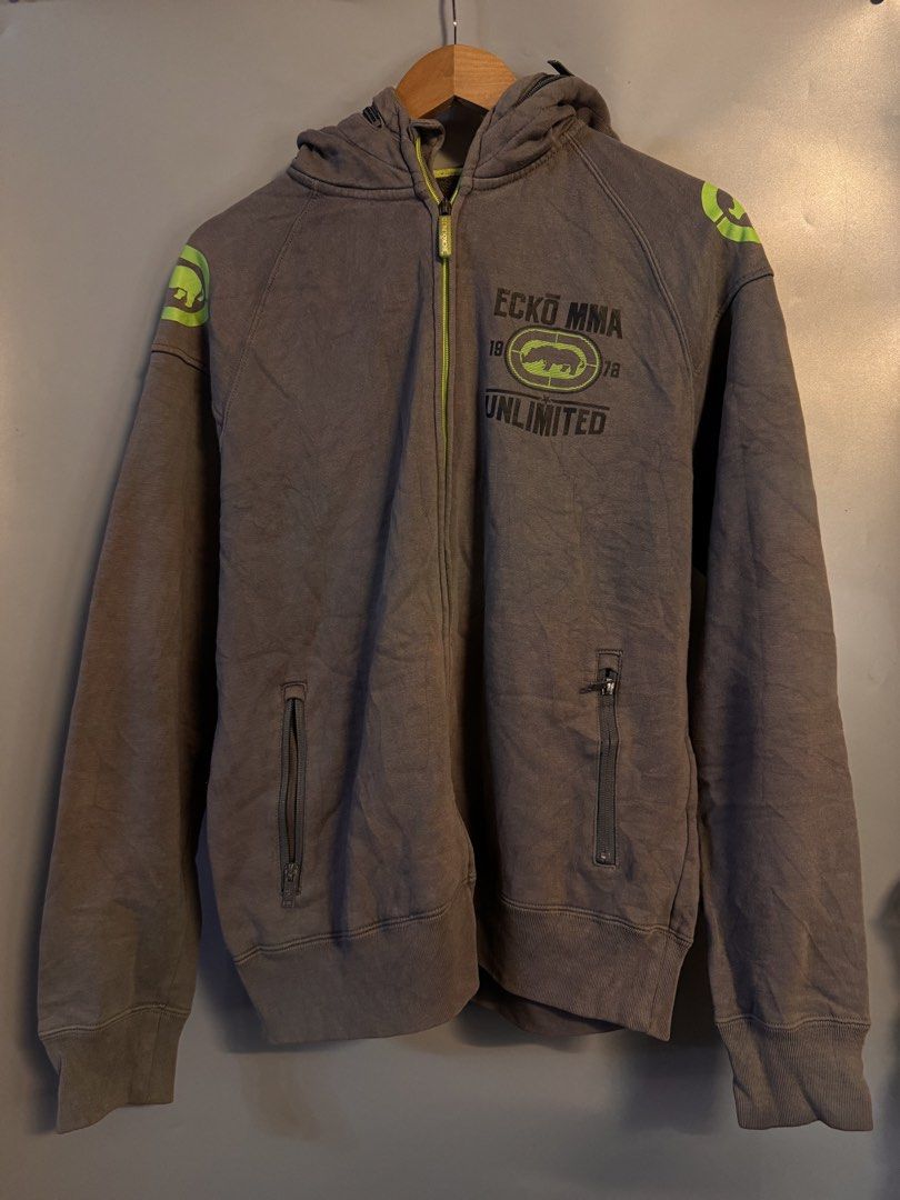 Ecko Unltd MMA Gray Full Zip Hoodie (Category: Coats, Jackets and Outerwear) located in Alaminos. Submitted by outfitcheck.ph (Listing ID 1469101285, Image 1). Description: - Brand: Ecko Unltd MMA Division - Color: Gray with neon green accents on zipper, lining, and shoulders - Size: Medium (inner tag verified) - Design: Large iconic rhino logo graphic print on chest and back - Features: Two front zip pockets, ribbed cuffs, and hem - Condition: E