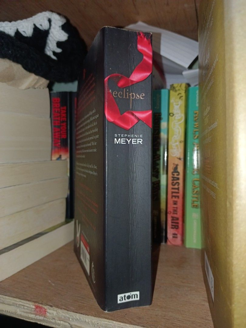 Eclipse by Stephenie Meyer | Twilight Saga Book 3 (Category: Storybooks) located in Cavite. Submitted by ir_archive (Listing ID 1469101382, Image 2). Description: ❗This is a pre-owned copy, so minor flaws and light to heavy shelf wear should be expected. • Paperback >> Minimal spine creases >> Tanned edges 📚 Genre: Young Adult (YA), Paranormal / Urban Fantasy, Romance ❓ Synopsis: In the overcast town of Forks, Washington, Bella Swan finds hersel