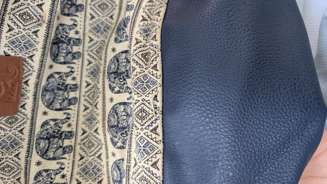 Elephant pattern drawstring backpack with faux leather base (Category: Backpacks) located in Manila. Submitted by alyssaapac81898 (Listing ID 1469000330, Image 3). Description: - Style: Boho drawstring backpack with eye-catching elephant and geometric patterns - Storage: Main compartment with secure rope closure plus a handy front zipped pocket - Durability: Features a stylish and sturdy navy blue faux leather bottom panel - Details: Finished wit