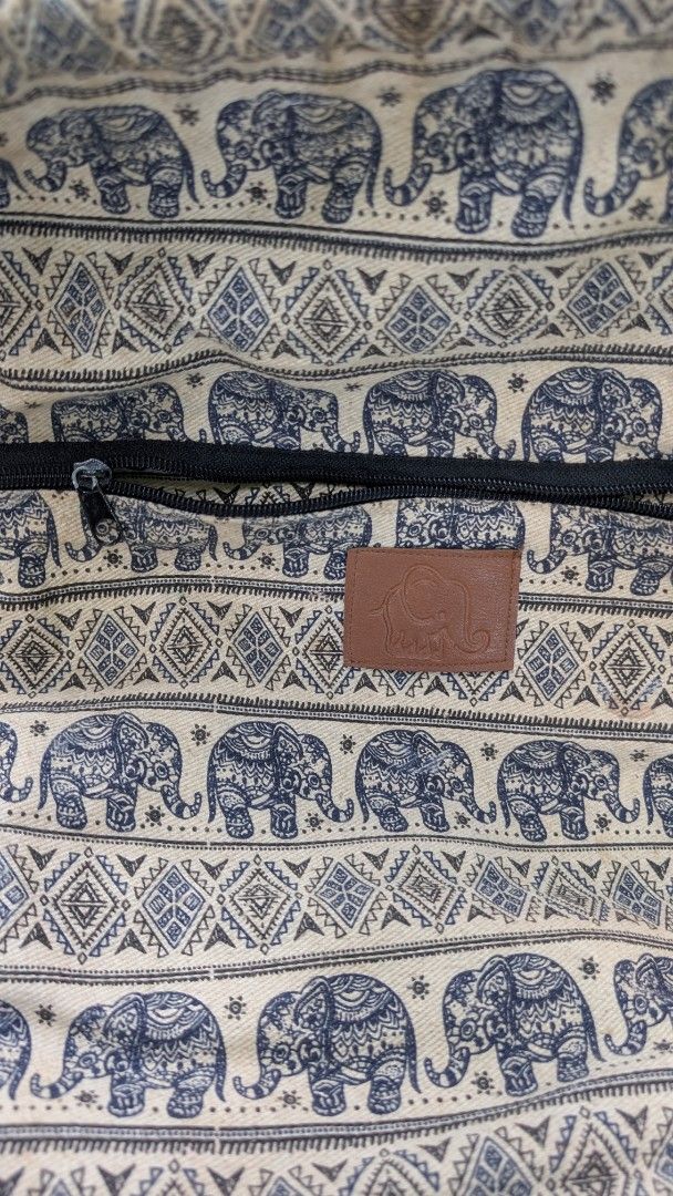 Elephant pattern drawstring backpack with faux leather base (Category: Backpacks) located in Manila. Submitted by alyssaapac81898 (Listing ID 1469000330, Image 2). Description: - Style: Boho drawstring backpack with eye-catching elephant and geometric patterns - Storage: Main compartment with secure rope closure plus a handy front zipped pocket - Durability: Features a stylish and sturdy navy blue faux leather bottom panel - Details: Finished wit