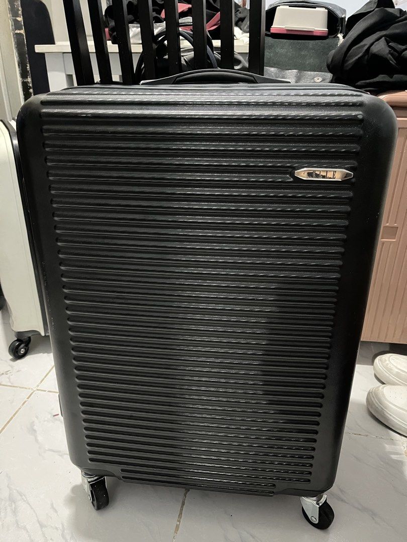 Elle black luggage (Category: Luggage) located in Marikina City. Submitted by patpatndls (Listing ID 1469135869, Image 1). Description: - Brand: Elle - Color: Black - Size: Medium (23-24 inches) - Design: Modern ribbed hardshell exterior with silver hardware and Elle logo badge - Security: Built-in combination lock - Mobility: Smooth-rolling multi-directional wheels with a sturdy retractable handle - Interior: Fully lined with multiple zippered m
