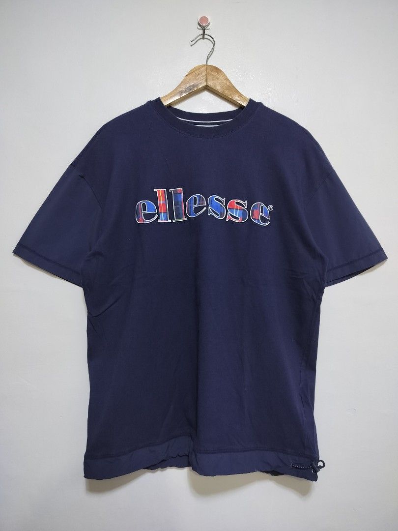 Ellesse Heritage Script Logo Embroidered T-Shirt (Category: Tshirts & Polo Shirts ) located in Taguig. Submitted by thriftybounce (Listing ID 1468945672, Image 1). Description: Fit : L Width : 22 Length : 28 Color Rate : 9.6/10 Issue : None.