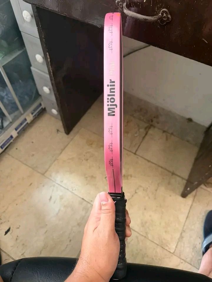 Enflexy Mjolnir 16mm Pickleball Paddle Pink (Category: Racket and Ball Sports) located in Atimonan. Submitted by brightriver_ee140a (Listing ID 1469097049, Image 2). Description: - Model: Enflexy Mjolnir Pickleball Paddle - Thickness: 16mm for enhanced stability and touch - Build: Durable unibody design with a striking black textured surface and pink trim - Grip: Standard wrapped black handle for comfortable play - Performance: Offers great contr