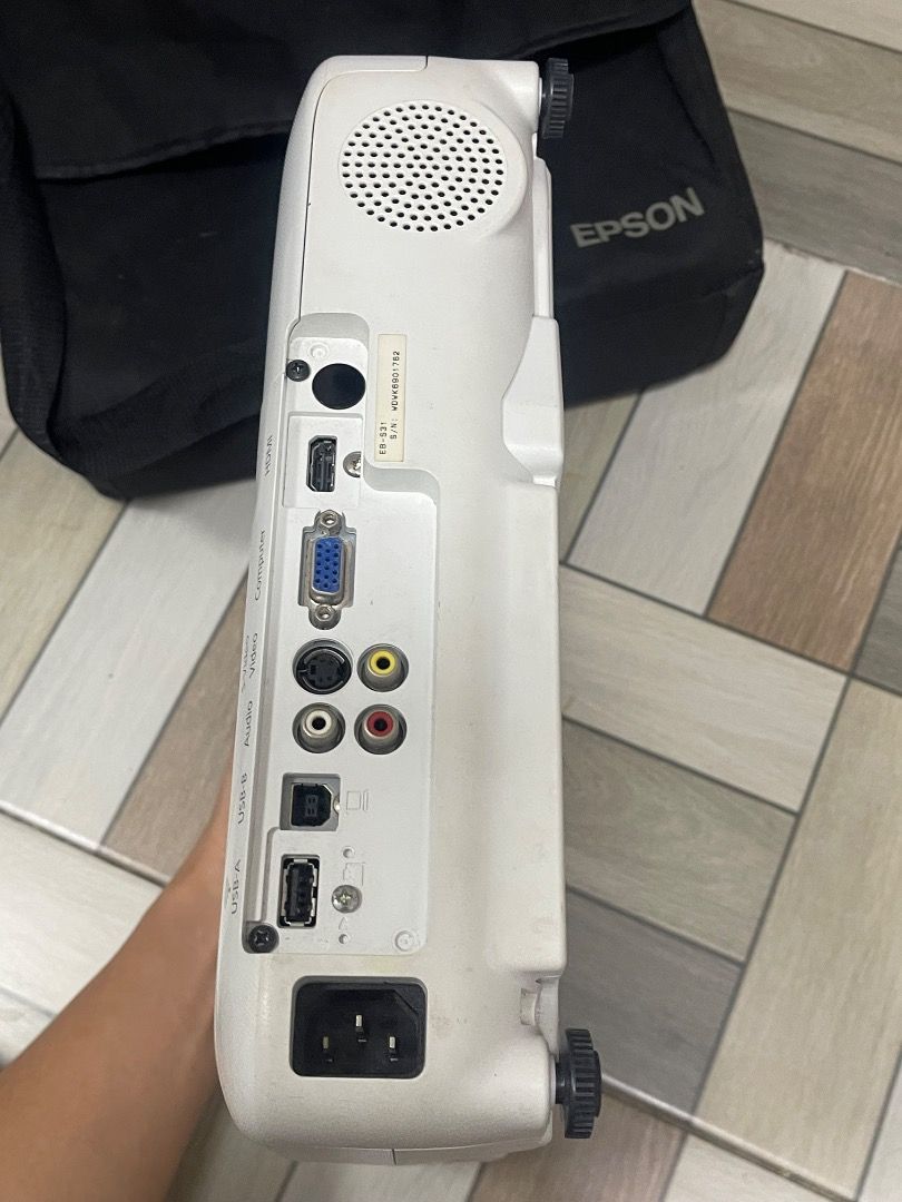 Epson EB-S31 LCD Projector (Category: Projectors) located in Muntinlupa City. Submitted by oddcloud.68011f (Listing ID 1468959472, Image 2). Description: - Model: Epson EB-S31 (H719C) - Color: White casing with top control buttons - Connectivity: HDMI, VGA, USB-A, USB-B, audio, and video inputs - Audio: Built-in speaker on the side panel - Inclusions: Original black Epson carry bag and standard AC power cable - Ideal Use: Great for office present