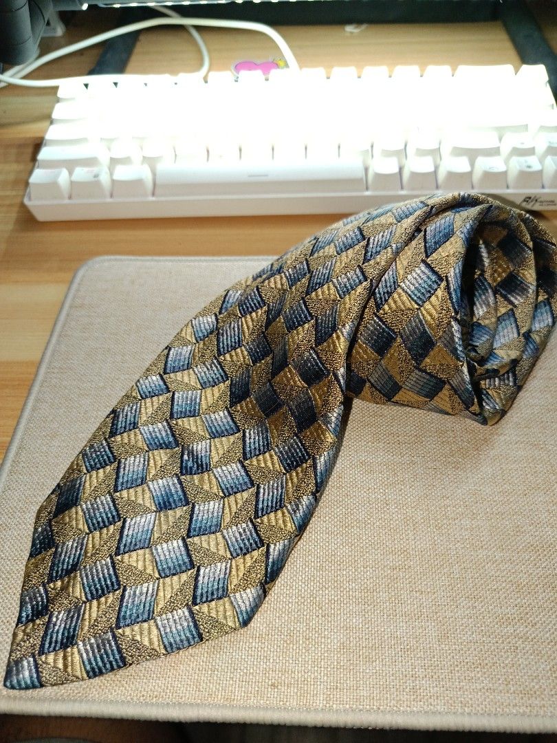 Ermenegildo Zegna Geometric Pattern Silk Tie (Category: Ties) located in Quezon City. Submitted by charlesfab66127 (Listing ID 1469086787, Image 1). Description: - Brand: Ermenegildo Zegna - Material: 100% High-quality Italian Silk - Design: Detailed geometric basketweave pattern in gold, blue, and grey tones - Features: Standard width blade, clean pointed tip, and branded fabric keeper loop - Ideal for: Formal events, weddings, and professional 