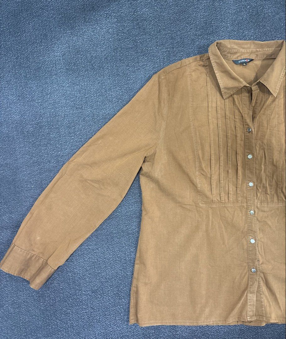 Essenxa Brown Long Sleeve Button Down Blouse Size XL (Category: Longsleeves) located in Quezon City. Submitted by fast.closetfinds (Listing ID 1469023755, Image 2). Description: - Brand: Essenxa - Size: XL - Color/Tone: Earthy brown - Style: Long sleeve button-down blouse with classic collar - Details: Elegant pleated front panel and button cuffs - Versatility: Perfect for both office work and casual outings - Condition: Good pre-owned condition,