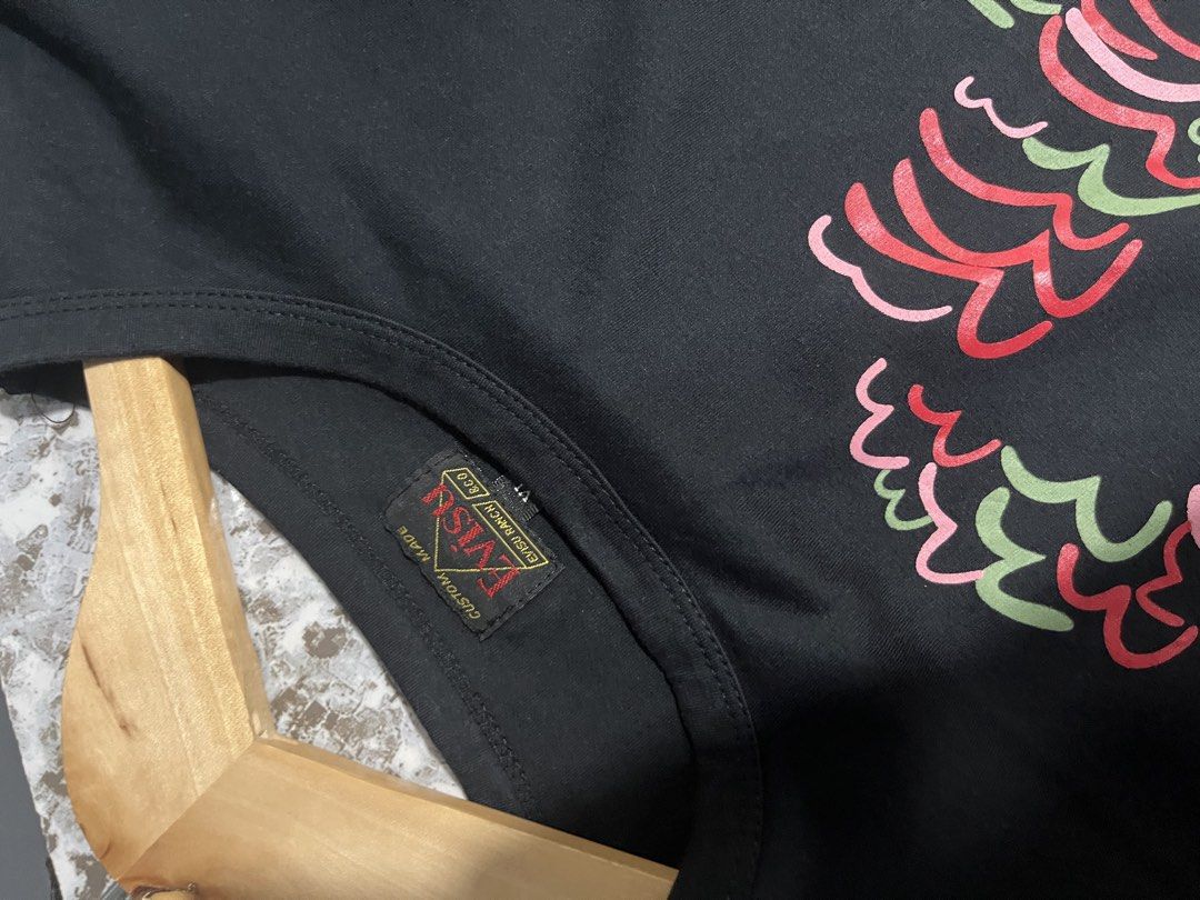Evisu Black Graphic T-Shirt (Category: Tshirts & Polo Shirts ) located in Maasin. Submitted by niconii090 (Listing ID 1468987269, Image 3). Description: - Brand: Evisu - Color: Black - Fit: Regular fit, straight hemline - Design: Colorful wave and brushstroke graphics on chest, Japanese character embroidery near hem with "Nobleness" text - Details: Custom Made Evisu Ranch neck tag - Material: Clean, comfortable cotton fabric - Fast shipping withi