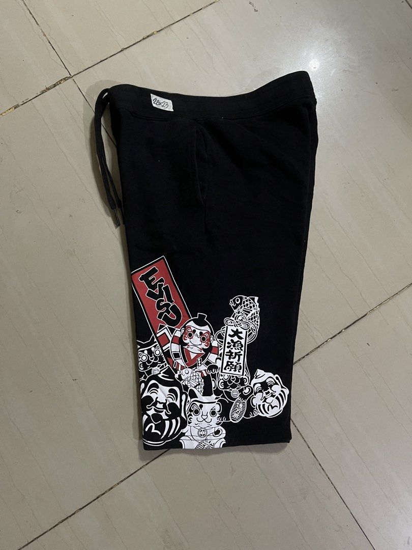 Evisu Heritage Custom Made Black Graphic Shorts Size M (Category: Shorts) located in Manila. Submitted by stuzzygod (Listing ID 1469084779, Image 3). Description: - Brand: Evisu Heritage (Custom Made) - Size 28 - Length 23 - Color: Black - Size: M (fits waist 28 to 33) - Material: Soft fleece cotton - Features: Drawstring waistband, front pockets, single back pocket - Details: Graphic prints on left leg and Japanese typography - Condition: Very c